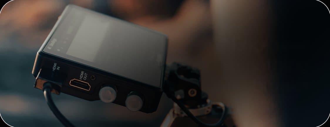 Camera monitor and rig handled by a studio engineer