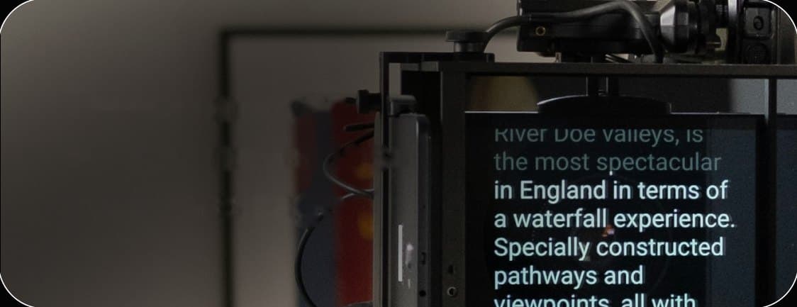 Presenter reading from a teleprompter mounted on a studio camera